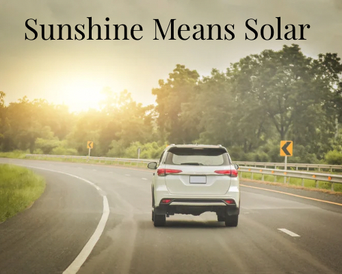 a car driving toward the sun
